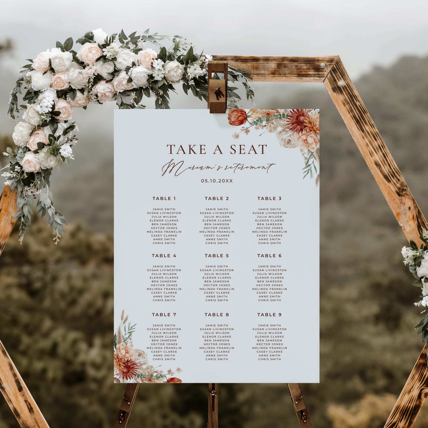 a wedding seating sign with flowers and greenery