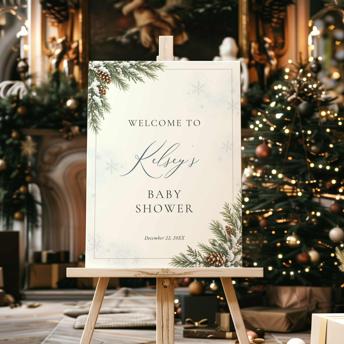 Baby It’s Cold Outside winter baby shower welcome sign with snowy evergreen branches, pinecones and blue snowflakes