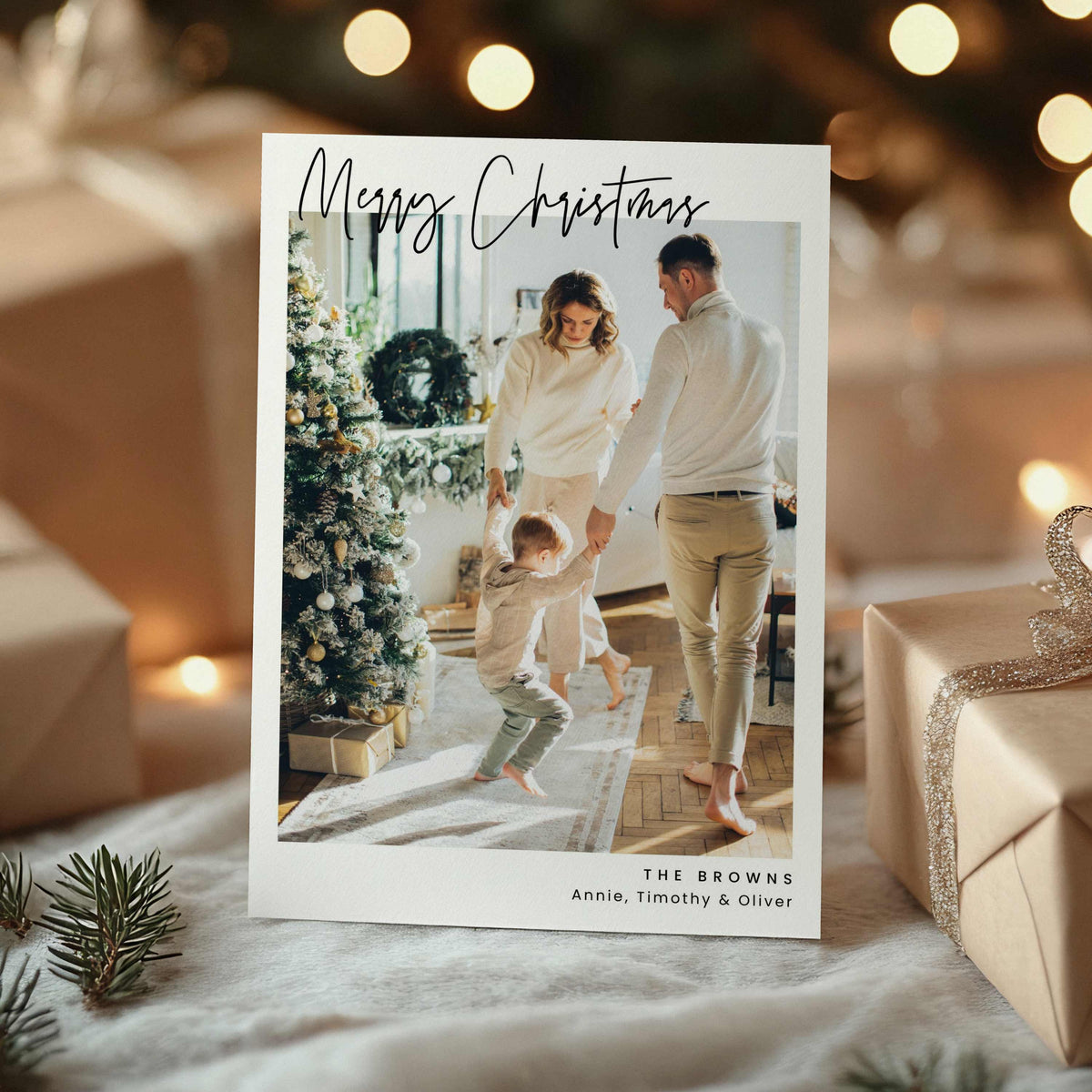 Minimal script Christmas photo card with large family photo and handwritten Merry Christmas text