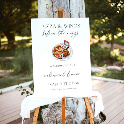 Pizza and Wings Before the Rings rehearsal dinner welcome sign featuring watercolor pizza, chicken wings, and an engagement ring box with elegant black typography on white.
