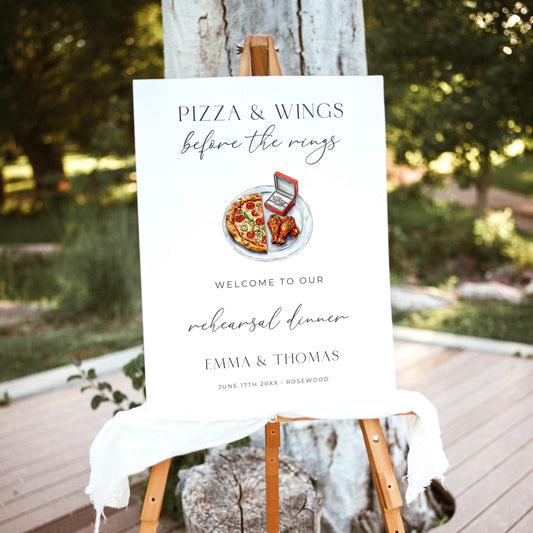 Pizza and Wings Before the Rings rehearsal dinner welcome sign featuring watercolor pizza, chicken wings, and an engagement ring box with elegant black typography on white.