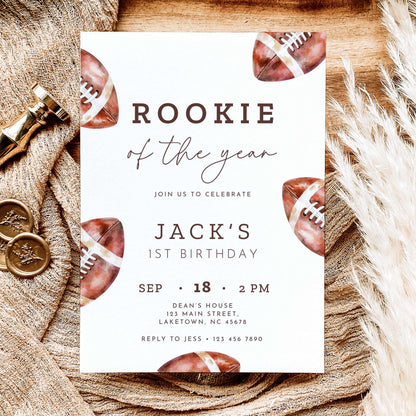 Rookie of the Year football first birthday invitation featuring vintage watercolor brown footballs, elegant script typography, and personalized birthday party details on a white background.