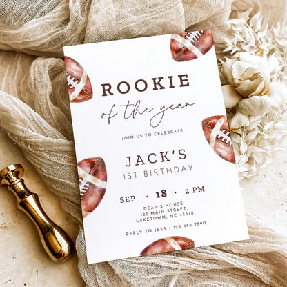 Rookie of the Year football first birthday invitation featuring vintage watercolor brown footballs, elegant script typography, and personalized birthday party details on a white background.