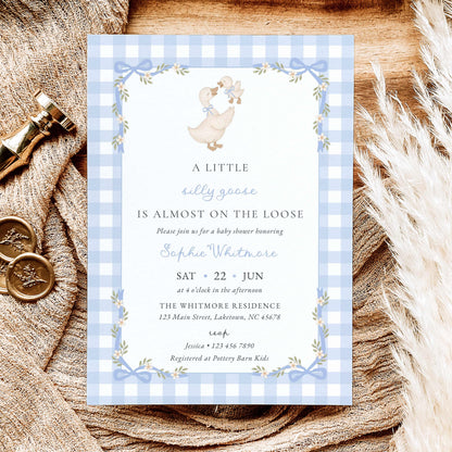 Blue gingham silly goose baby shower invitation with watercolor mother goose and gosling, pastel blue bows, white daisies, floral ribbon frame, and vintage lettering.